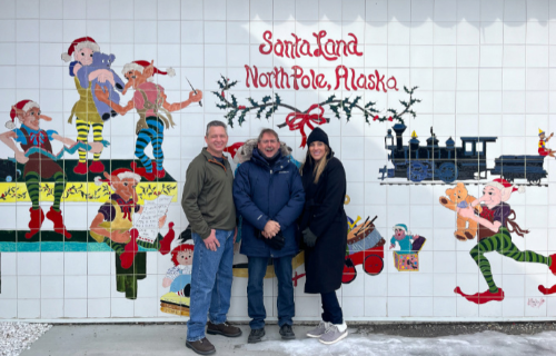 North-Pole1 Marty, Becca and Brian in the town of North Pole posing for a group photo in front of a Christmas mural