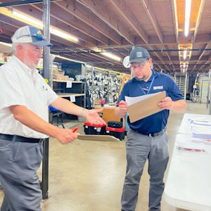IMS-photo two men looking over inventory sheet in a warehouse