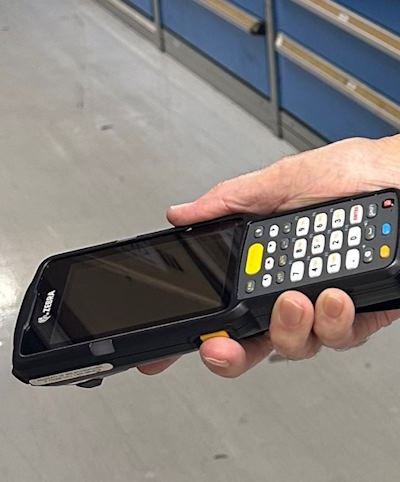 Zebra4 person holding bar code scanning device